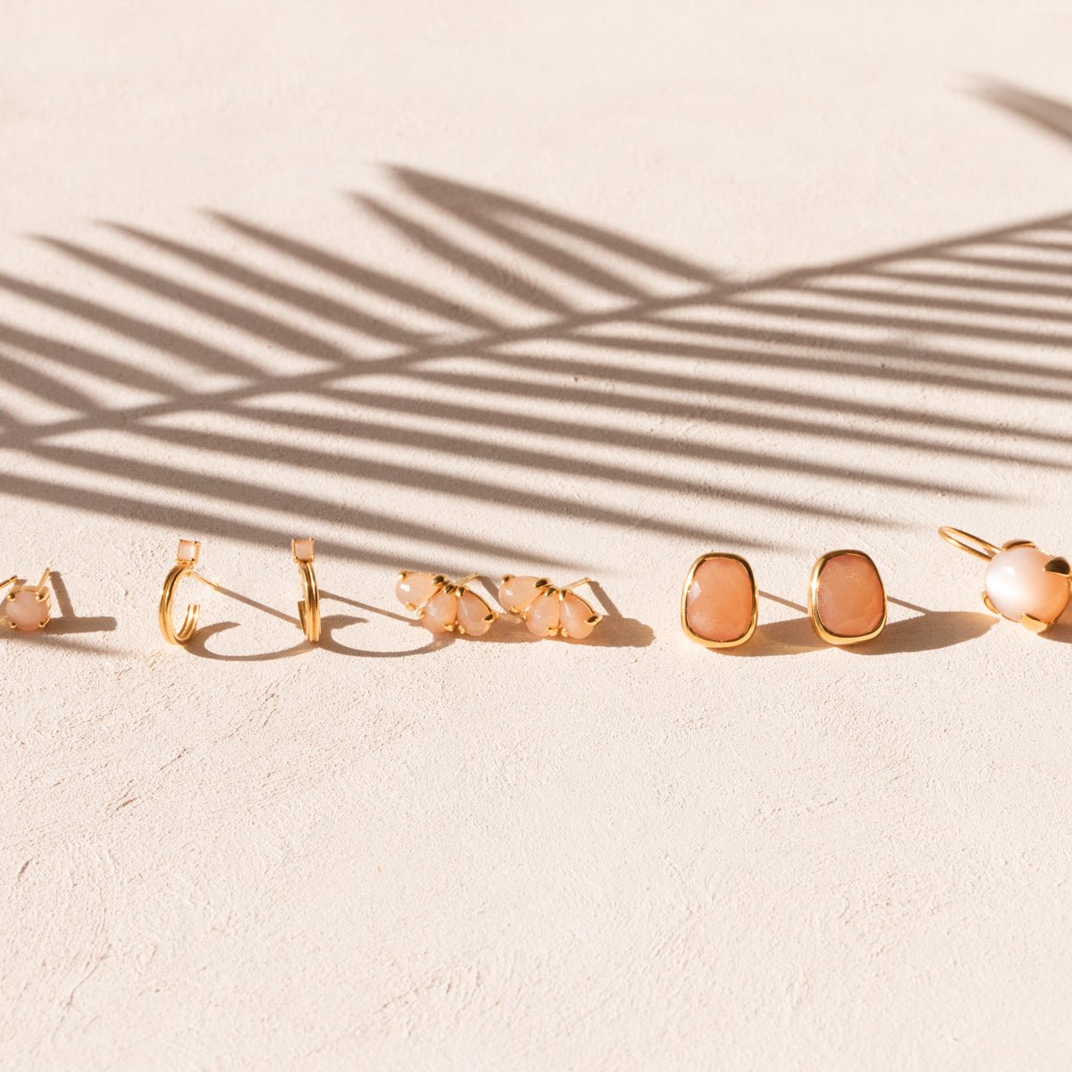 RADIANT ARC HUGGIE HOOPS - PEACH MOONSTONE & GOLD - SO PRETTY CARA COTTER